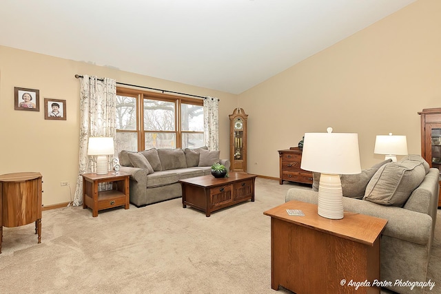 living area featuring lofted ceiling, light carpet, and baseboards