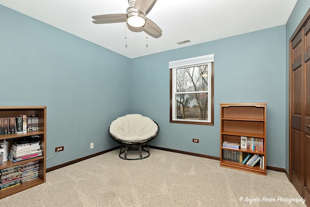 sitting room with a ceiling fan, carpet, visible vents, and baseboards