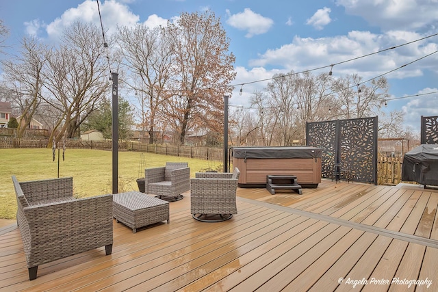 wooden terrace featuring a fenced backyard, a lawn, a hot tub, and grilling area