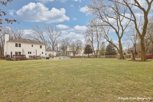 view of yard with a fenced backyard and a wooden deck