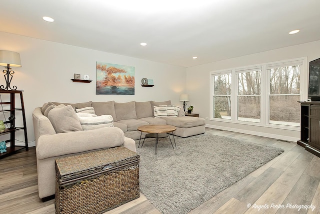 living area featuring wood finished floors and recessed lighting