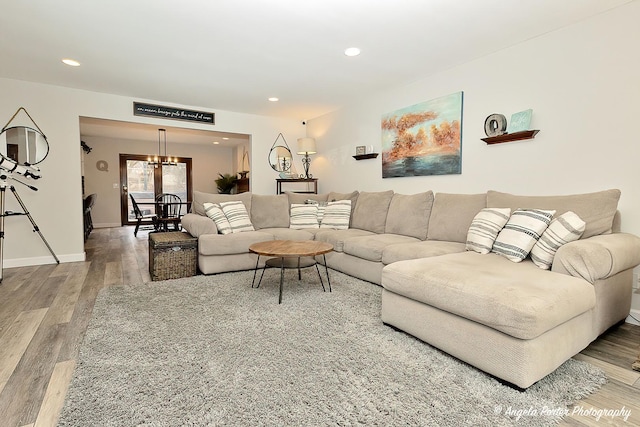 living room with recessed lighting, baseboards, and wood finished floors