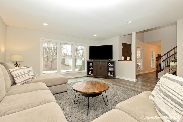 living area with baseboards, stairway, wood finished floors, and recessed lighting