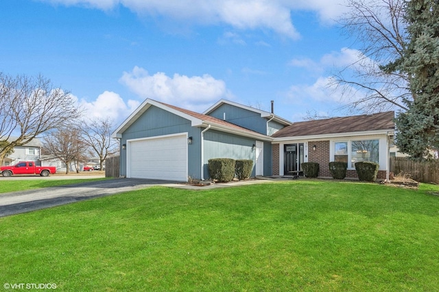 view of front of property with a front yard, fence, driveway, a garage, and brick siding