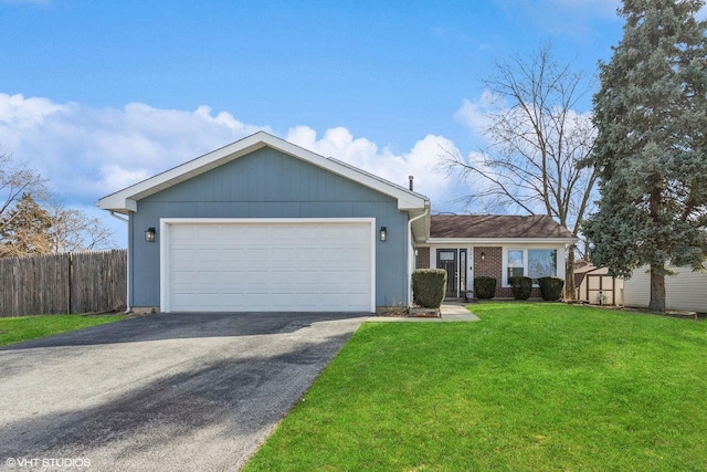 ranch-style house featuring aphalt driveway, fence, a front yard, a garage, and brick siding