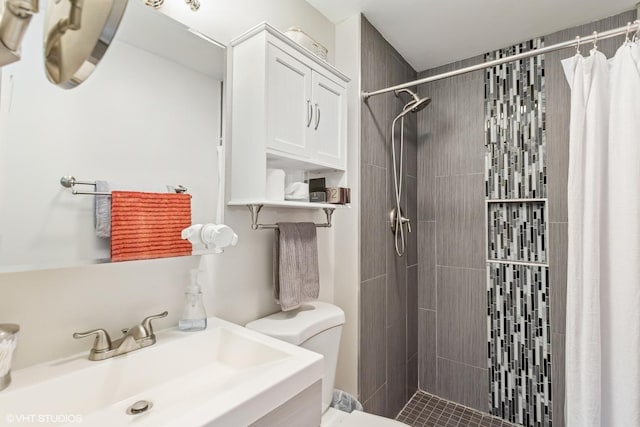 bathroom featuring a shower stall, toilet, and a sink