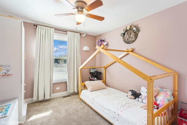 carpeted bedroom with visible vents, baseboards, and ceiling fan