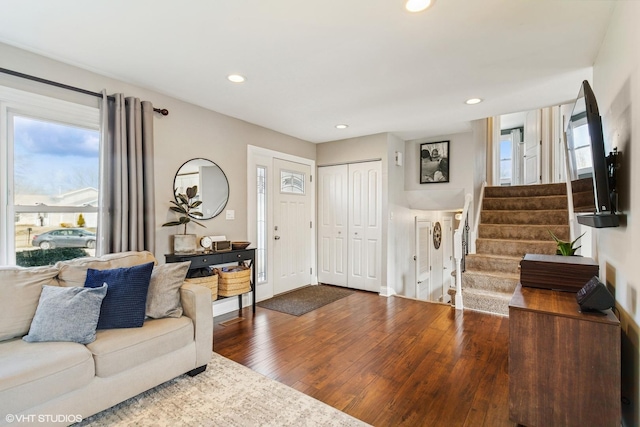 living area with recessed lighting, stairway, baseboards, and dark wood-style floors