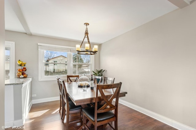 dining room featuring baseboards, a notable chandelier, and dark wood-style floors