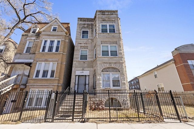 view of property featuring a fenced front yard and stone siding