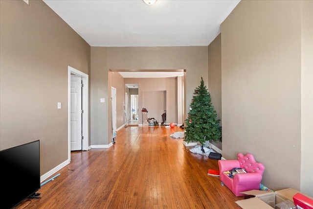 hallway with baseboards and wood finished floors