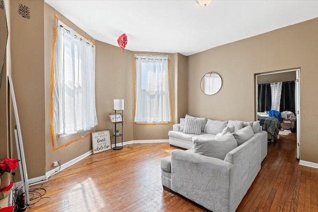 living room with hardwood / wood-style floors and baseboards