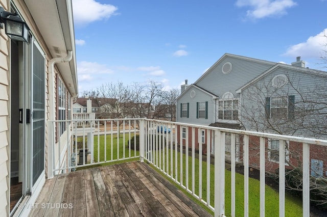 wooden deck with a lawn