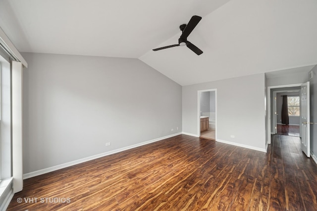 unfurnished bedroom featuring wood finished floors, connected bathroom, baseboards, ceiling fan, and vaulted ceiling