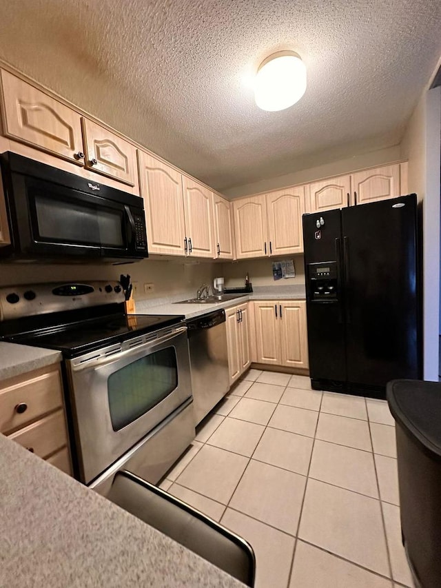 kitchen featuring black appliances, light brown cabinets, a textured ceiling, light tile patterned flooring, and light countertops