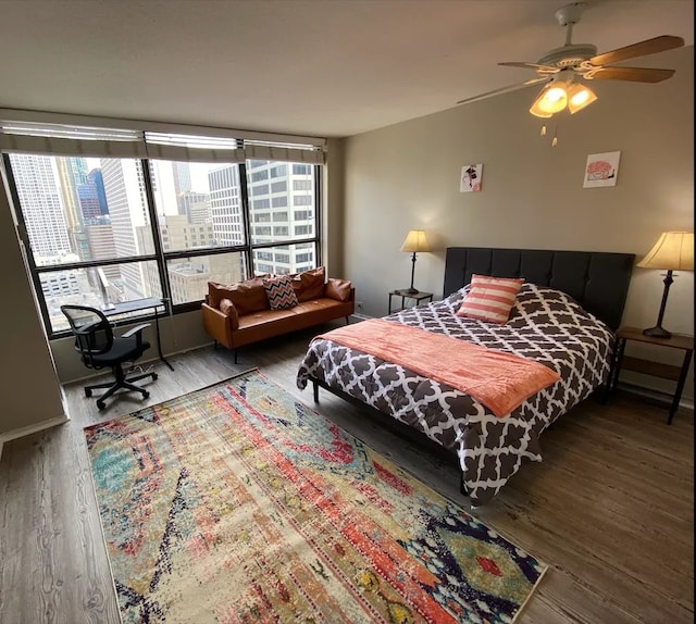 bedroom with a ceiling fan and wood finished floors