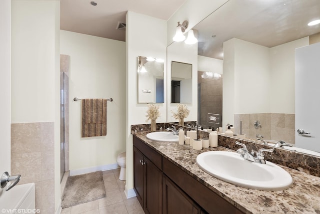 bathroom with toilet, tile patterned flooring, visible vents, and a sink