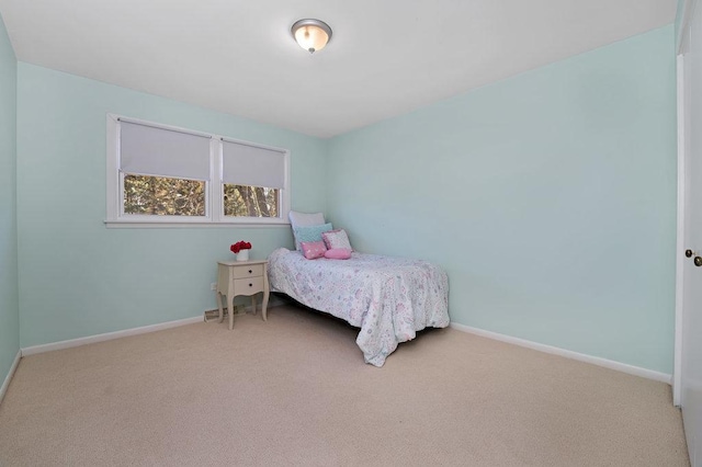 carpeted bedroom featuring baseboards