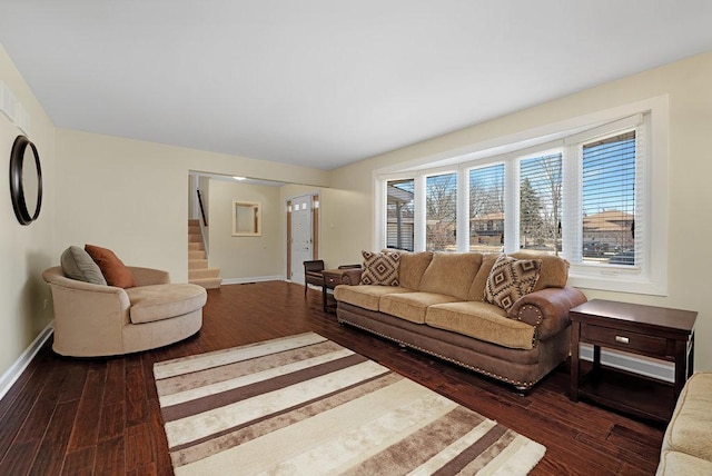 living area featuring stairs, baseboards, and wood finished floors