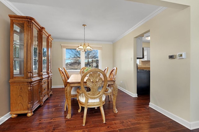 dining room with ornamental molding, dark wood finished floors, and baseboards