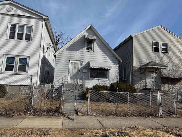 view of front facade with a fenced front yard and a gate