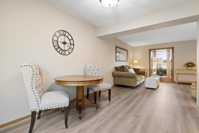 living area with light wood finished floors and baseboards