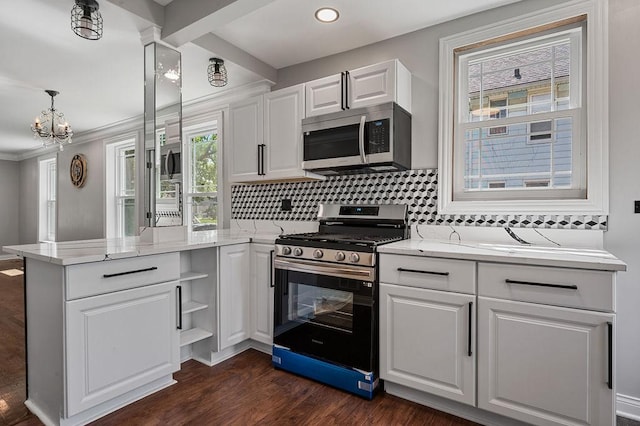 kitchen featuring tasteful backsplash, white cabinets, appliances with stainless steel finishes, a peninsula, and open shelves