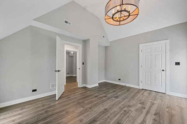 bonus room with baseboards, visible vents, and wood finished floors