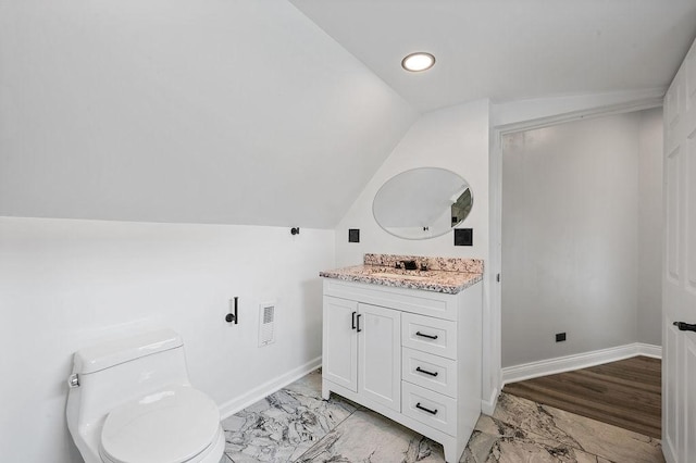 bathroom featuring vanity, visible vents, vaulted ceiling, marble finish floor, and baseboards