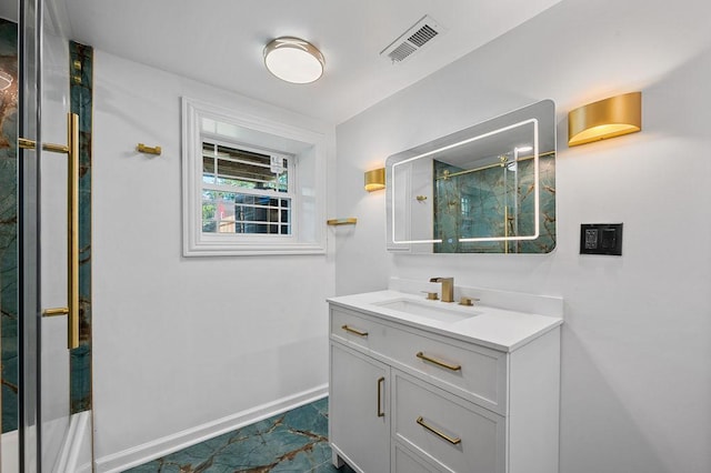 full bath featuring baseboards, a marble finish shower, visible vents, and vanity