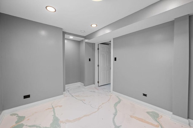 empty room with recessed lighting and baseboards