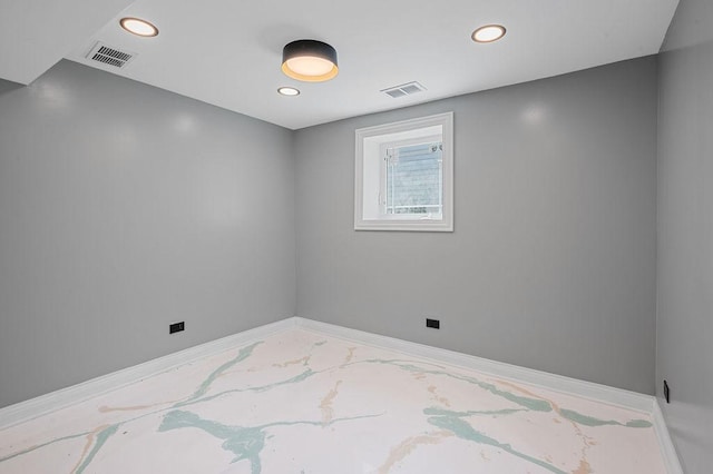 unfurnished room featuring baseboards, visible vents, and recessed lighting