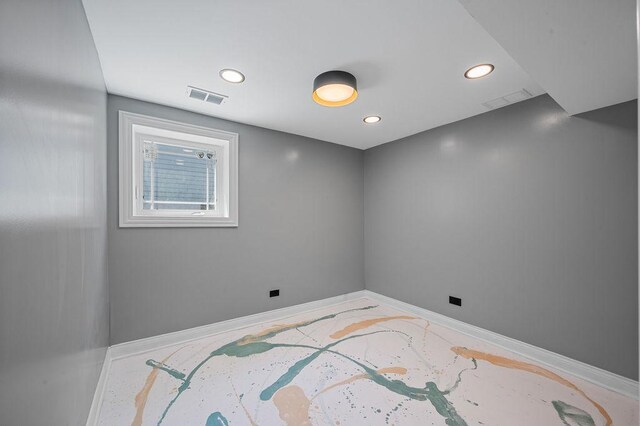 spare room with baseboards, visible vents, and recessed lighting