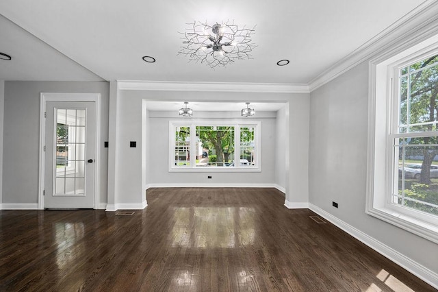 unfurnished living room with a chandelier, plenty of natural light, and visible vents