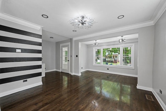 interior space with ornamental molding, visible vents, and wood finished floors