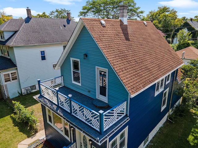 back of property with a chimney