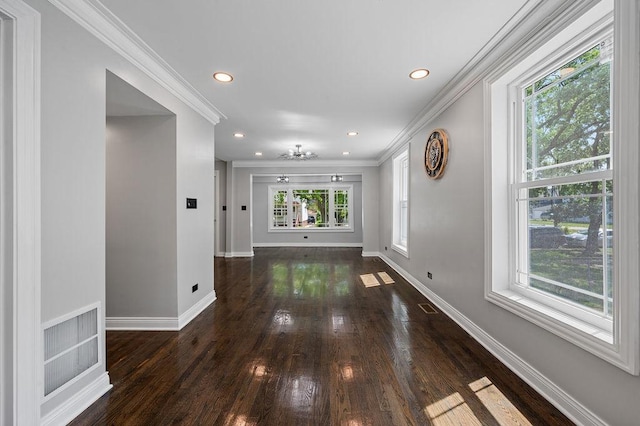 interior space with baseboards, a wealth of natural light, and crown molding