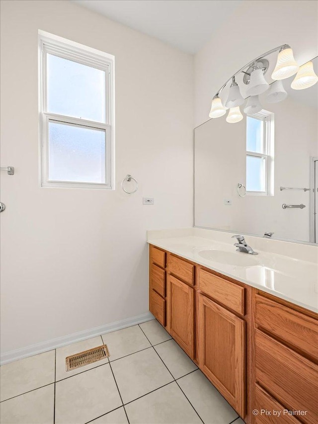 bathroom featuring visible vents, baseboards, vanity, and tile patterned floors