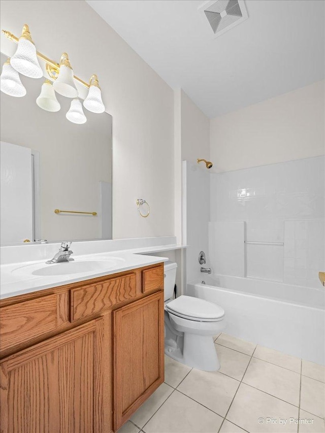 bathroom featuring toilet, vanity, visible vents, tile patterned floors, and washtub / shower combination