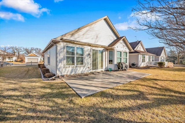 rear view of house with a yard and a patio area