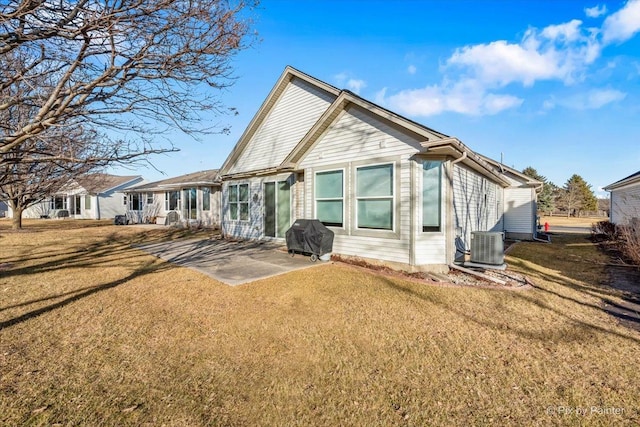 back of house with a patio area, a lawn, and central AC unit