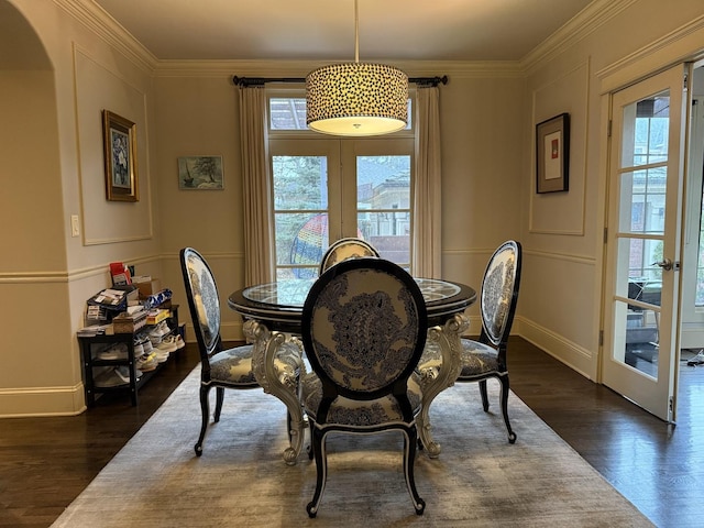 dining space with french doors, dark wood-style flooring, and ornamental molding