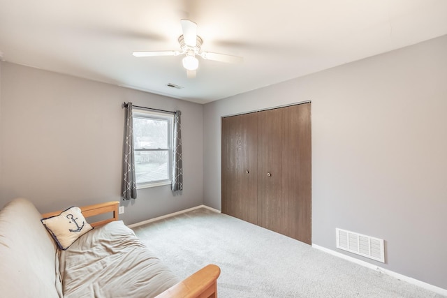 living area featuring baseboards, visible vents, ceiling fan, and carpet flooring