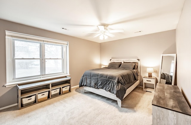 carpeted bedroom with baseboards, visible vents, and ceiling fan