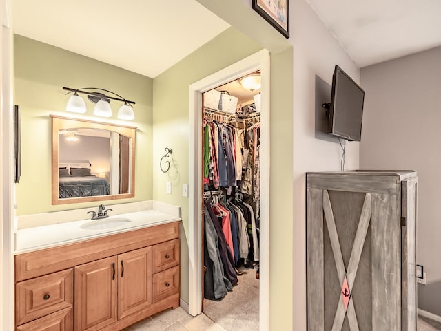 bathroom featuring a walk in closet and vanity