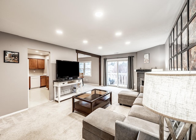 living area with light carpet, a fireplace, baseboards, and recessed lighting