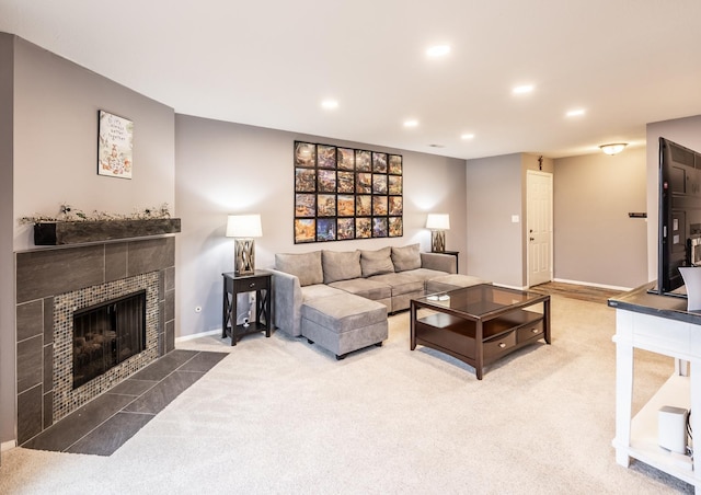 living room with baseboards, a tiled fireplace, carpet flooring, and recessed lighting