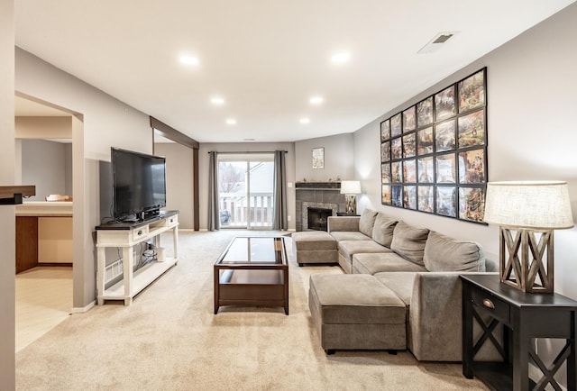 living room with carpet, a fireplace, recessed lighting, visible vents, and baseboards