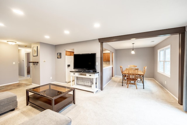 living area featuring recessed lighting, baseboards, and light colored carpet