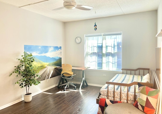 bedroom with a textured ceiling, a ceiling fan, baseboards, and wood finished floors